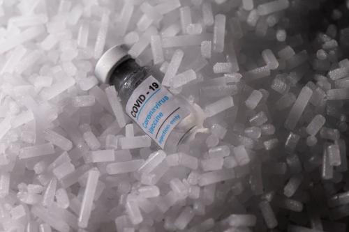 Vials labelled "COVID-19 Coronavirus Vaccine" are placed on dry ice in this illustration taken, December 4, 2020. Picture taken December 4, 2020. REUTERS/Dado Ruvic/Illustration