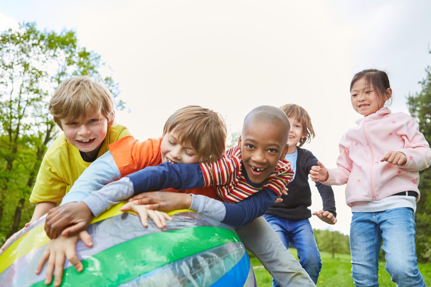 Children playing with a ball in the park.