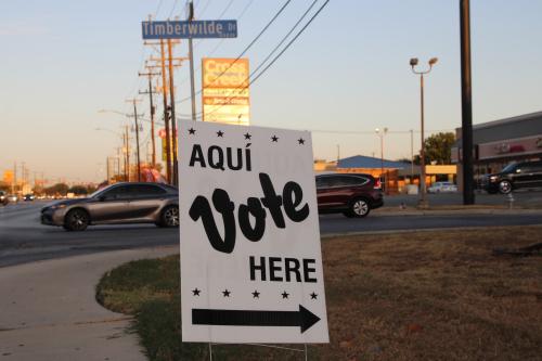 An Aqui Vote Here sign along Grissom road at the Great Northwest Public Library in San Antonio, Texas, USA, on October 21, 2024.