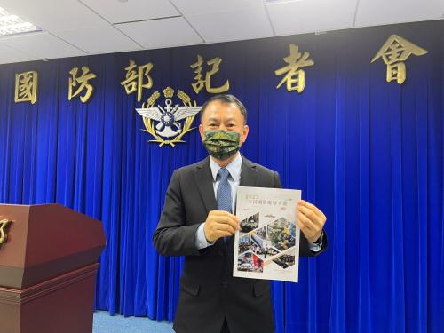 All-Out Defence Mobilization Agency Director Shen Wei-chih poses with a printout of the newest version of Civil Defence Handbook after a press conference in Taipei, Taiwan, June 13, 2023.