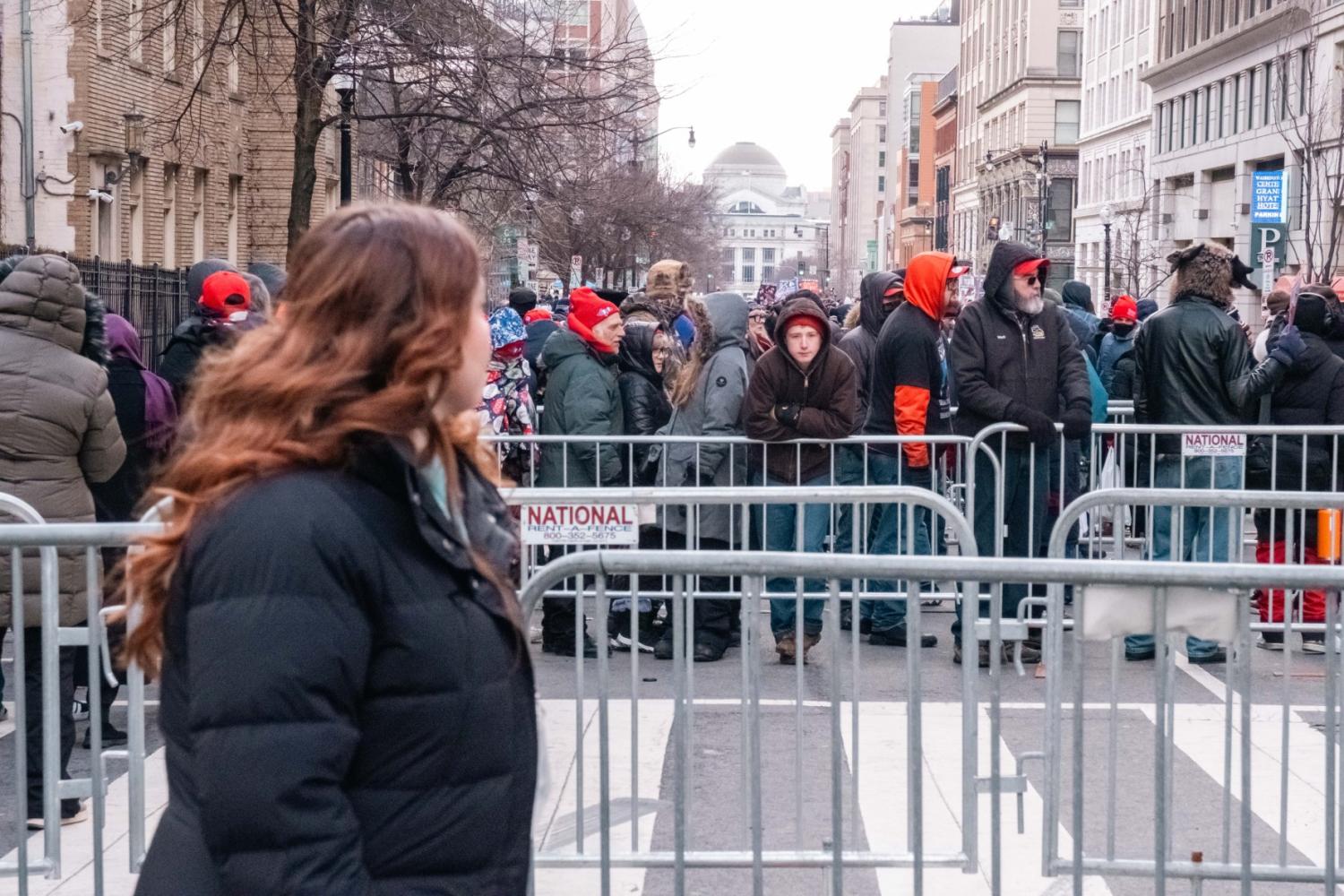 Trump supporters wait on line behind barricades to get into the Capital One Arena to watch the televised inauguration.