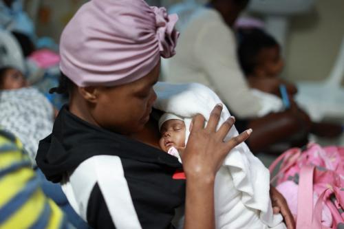 A Haitian mother holds her baby while waiting to receive medical care at a local hospital, in Santo Domingo, Dominican Republic January 14, 2025. REUTERS/Erika Santelices