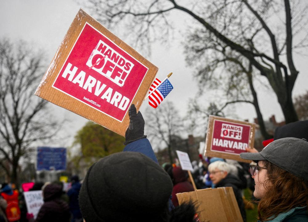 Demonstrators rally on Cambridge Common in a protest organized by the City of Cambridge calling on Harvard leadership to resist interference at the university by the federal government in Cambridge, Massachusetts, U.S. on April 12, 2025.